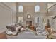 Bright living room featuring high ceilings, fireplace, hardwood floors, and elegant furnishings at 426 Lanesborough Dr, Marietta, GA 30064