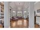 Bright living room featuring a tray ceiling, hardwood floors, and large windows with a seating area at 426 Lanesborough Dr, Marietta, GA 30064