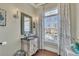 Stylish powder room with decorative mirror, sconces, and a charming window with plenty of natural light at 426 Lanesborough Dr, Marietta, GA 30064
