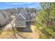 Rear exterior of a home with a deck overlooking the backyard, surrounded by trees and lush greenery at 426 Lanesborough Dr, Marietta, GA 30064