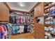 Spacious walk-in closet with custom wood shelving and rods for ample storage at 426 Lanesborough Dr, Marietta, GA 30064