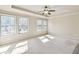 Bright bedroom with three large windows, a ceiling fan and neutral carpet at 1100 N North Village Drive Dr, Decatur, GA 30032