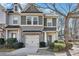 Charming townhome with a one-car garage, brick accents, and manicured landscaping at 1100 N North Village Drive Dr, Decatur, GA 30032