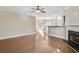 Open-concept living room with hardwood floors, fireplace, and views of the adjacent dining area at 1100 N North Village Drive Dr, Decatur, GA 30032