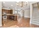 Open-concept living space with hardwood floors, a kitchen island, and a staircase at 1100 N North Village Drive Dr, Decatur, GA 30032