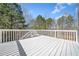 Spacious white deck with railing that overlooks a tree-filled backyard at 237 Elmbrook Ln, Canton, GA 30114