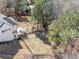 Aerial view of backyard with deck, patio, and lush landscaping, partially fenced with wooded backdrop at 237 Elmbrook Ln, Canton, GA 30114