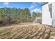 Large backyard showing the back of the home, yard space, and surrounding treeline at 237 Elmbrook Ln, Canton, GA 30114