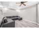 Basement area featuring durable wood flooring, modern ceiling fan, and comfortable seating at 237 Elmbrook Ln, Canton, GA 30114