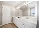 Bright bathroom features a dual sink vanity, large mirror, and walk-in shower at 237 Elmbrook Ln, Canton, GA 30114