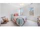 Cozy bedroom with a rocking chair, natural light, and neutral carpet at 237 Elmbrook Ln, Canton, GA 30114