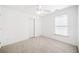 Minimalist bedroom featuring neutral carpet, natural light, and a ceiling fan at 237 Elmbrook Ln, Canton, GA 30114