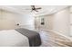 Neutral bedroom featuring modern fan, tray ceiling, and wood flooring with plenty of natural light at 237 Elmbrook Ln, Canton, GA 30114