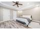 Neutral bedroom with a ceiling fan, a large bed, and two closets for ample storage space at 237 Elmbrook Ln, Canton, GA 30114