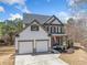 Charming two-story home with a well-manicured lawn and a two-car garage at 237 Elmbrook Ln, Canton, GA 30114