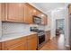 Modern kitchen featuring wooden cabinets, stainless appliances, and marble backsplash at 237 Elmbrook Ln, Canton, GA 30114