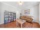 Cozy living room featuring hardwood floors, a bookshelf, and a comfortable sofa at 237 Elmbrook Ln, Canton, GA 30114