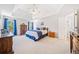 Spacious main bedroom featuring a tray ceiling, hardwood furniture, and natural light at 237 Elmbrook Ln, Canton, GA 30114