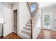 Carpeted staircase with wooden banister leading to the upper level at 237 Elmbrook Ln, Canton, GA 30114