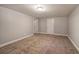 Spacious basement area featuring carpeted flooring and neutral walls at 26 Wey Bridge Ct, White, GA 30184