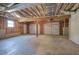 Unfinished basement space with concrete floors, exposed ceiling, and access to a two-car garage at 26 Wey Bridge Ct, White, GA 30184