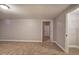 Spacious basement area with neutral walls and carpeting at 26 Wey Bridge Ct, White, GA 30184