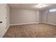 Open basement area with neutral walls and carpeting at 26 Wey Bridge Ct, White, GA 30184