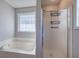 Bathroom featuring a white tub and frosted glass enclosed shower at 26 Wey Bridge Ct, White, GA 30184