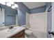 Bathroom features a white sink and vanity, toilet, and shower-tub combo with blue walls at 26 Wey Bridge Ct, White, GA 30184