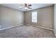 Bedroom with neutral walls, carpet, ceiling fan, and a bright window showcasing natural light at 26 Wey Bridge Ct, White, GA 30184