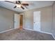 Bedroom with carpet, ceiling fan, two doors and neutral walls creating a cozy space at 26 Wey Bridge Ct, White, GA 30184