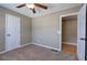 Neutral bedroom with carpet, ceiling fan, and a glimpse into a closet with hardwood flooring at 26 Wey Bridge Ct, White, GA 30184