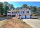 Charming home with a covered porch, two-car garage, and well-maintained lawn and mature landscaping at 26 Wey Bridge Ct, White, GA 30184