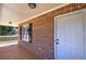 Inviting front porch featuring brick accents, a white door, and a charming outdoor space at 26 Wey Bridge Ct, White, GA 30184