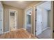 Hallway featuring hardwood floors and multiple doorways leading to bedrooms and bathrooms at 26 Wey Bridge Ct, White, GA 30184