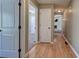 Hallway featuring hardwood floors and multiple doorways leading to living room and bedrooms at 26 Wey Bridge Ct, White, GA 30184