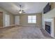 Bright living room featuring a fireplace, ceiling fan, and large windows for plenty of natural light at 26 Wey Bridge Ct, White, GA 30184