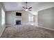 Spacious living room with a ceiling fan, fireplace, and large windows for natural light at 26 Wey Bridge Ct, White, GA 30184