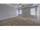 Spacious main bedroom with a trey ceiling, fan and large windows at 26 Wey Bridge Ct, White, GA 30184