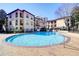 Community pool area with a view of surrounding multi-story condos at 3777 Peachtree Ne Rd # 722, Brookhaven, GA 30319