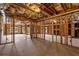 Unfinished basement featuring exposed beams, ductwork, a fireplace cutout, and walkout door to the yard at 5080 Riverlake Dr, Peachtree Corners, GA 30097