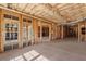 Unfinished basement featuring rough framing, concrete flooring and natural light from the windows, waiting to be customized at 5080 Riverlake Dr, Peachtree Corners, GA 30097