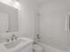 Bright bathroom featuring a tub/shower, tile surround, white vanity with sink, and modern chrome fixtures at 5080 Riverlake Dr, Peachtree Corners, GA 30097