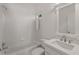 Bright bathroom featuring a tub/shower, tile surround, white vanity with sink, and modern chrome fixtures at 5080 Riverlake Dr, Peachtree Corners, GA 30097