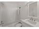 All-white bathroom with a shower-over-tub setup and a modern vanity at 5080 Riverlake Dr, Peachtree Corners, GA 30097