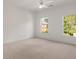 Bright bedroom with neutral carpet, ceiling fan, and double hung windows providing lots of natural light at 5080 Riverlake Dr, Peachtree Corners, GA 30097