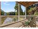 Relaxing deck with lake views, decorative railing and ample space for outdoor seating at 5080 Riverlake Dr, Peachtree Corners, GA 30097