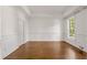 Dining room boasting hardwood floors, wainscoting detail, a tray ceiling, and a double hung window for natural light at 5080 Riverlake Dr, Peachtree Corners, GA 30097