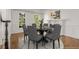 Elegant dining room with hardwood floors, fireplace, and view of the backyard at 5080 Riverlake Dr, Peachtree Corners, GA 30097