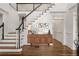 Elegant foyer with staircase, hardwood floors, and decorative table at 5080 Riverlake Dr, Peachtree Corners, GA 30097